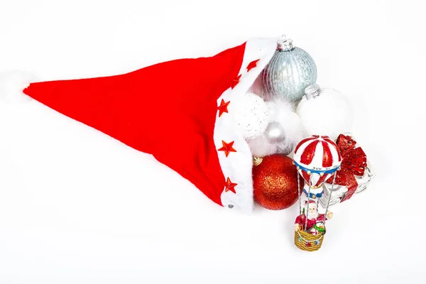 Santa Claus hat cap with Christmas presents and balls ornaments on white background