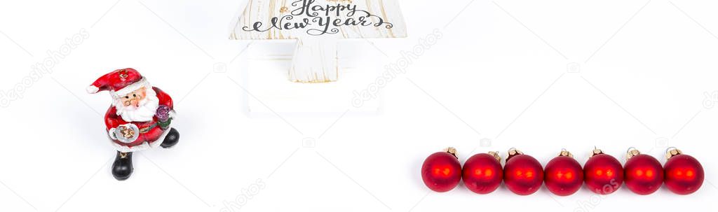 Beautiful Minimal Christmas wood white tree with Merry Christmass and happy new year written, with small Santa Claus and red balls, on white backgound. Banner panoramic