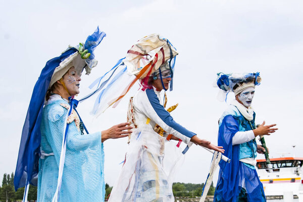 ROUEN, FRANCE - JULY Circa, 2016. Performers men in costume carnival gathered on a quay of the river Seine for Armada parade, international meeting of very old boats