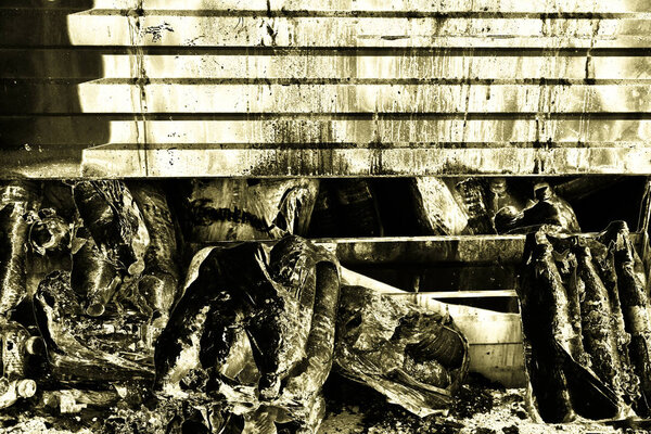 Damaged industry supermarket after arson fire with burn debris of twisted metallic wood structure after intense burning fire disaster ruins waiting for investigation for insurance. Painted gold color effect dramatic atmosphere