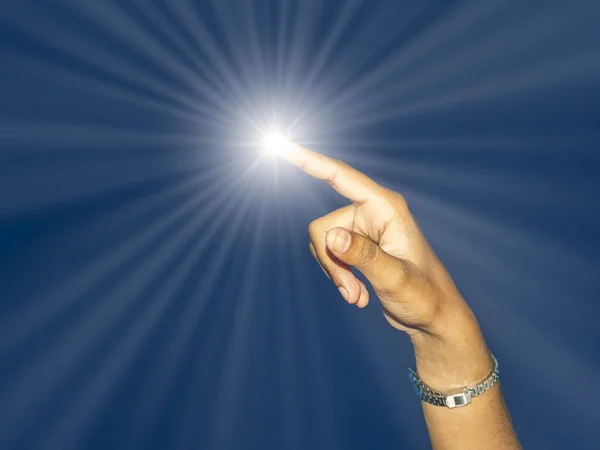 Close up of a young indian woman hand pointing finger as touching screen, with light ray, isolated on blue background.