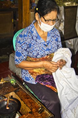 Woman indonesian painting Batik - Balinese traditional painting on fabric.