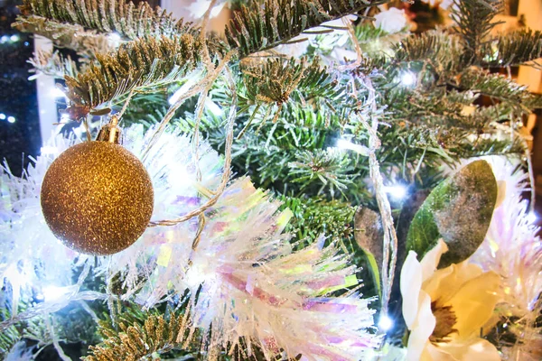 Árbol de Navidad con juguetes y flores rojas púrpura y blanca en el interior . — Foto de Stock