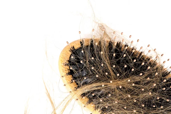 Wood hairbrush on white background. Close-up with long brown hair — Stock Photo, Image