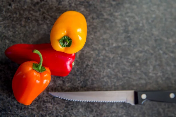 Small Yellow Orange Red Sweet Peppers Black Background Kitchen Knife — Stock Photo, Image