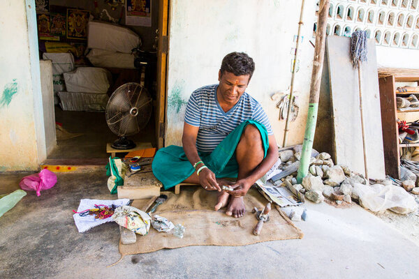 Indian sculptor man, engraving small ganesh statue