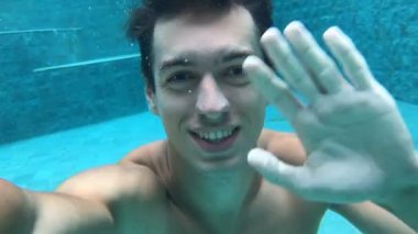 Selfi ise havuza dalış yapan erkek. Sualtı yüzme. Adam havzası içinde yüzüyor