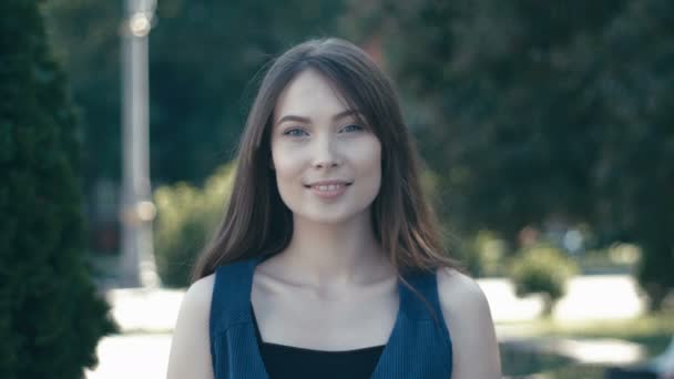 Retrato de jovem bonita mulher ao ar livre no fundo da rua — Vídeo de Stock