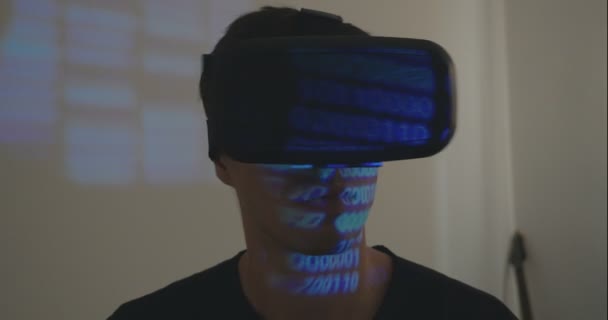 Man programmer wearing virtual reality hemlet or VR Glasses with binary code reflection — Stock Video