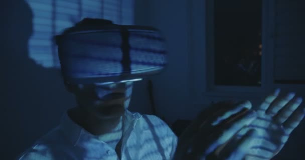 Futuristic Man programmer wearing virtual reality hemlet or VR Glasses with binary code reflection — Stock Video