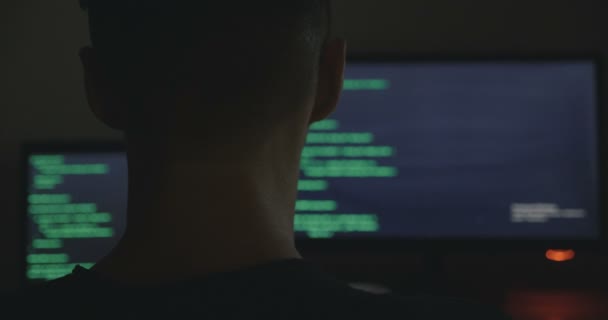 IT professional hacker programmer is working on computer in cyber security center at night — Stock Video