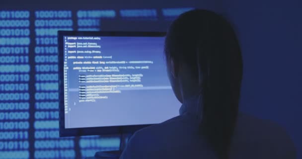 Portrait of young woman hacker programmer working at a computer in the data center — Stock Video