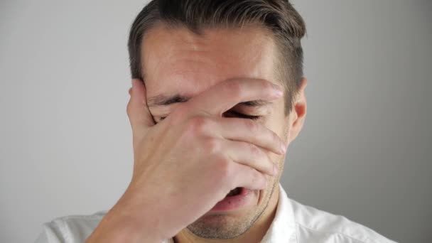 Young man in despair crying covering his face with his hand — Stock Video