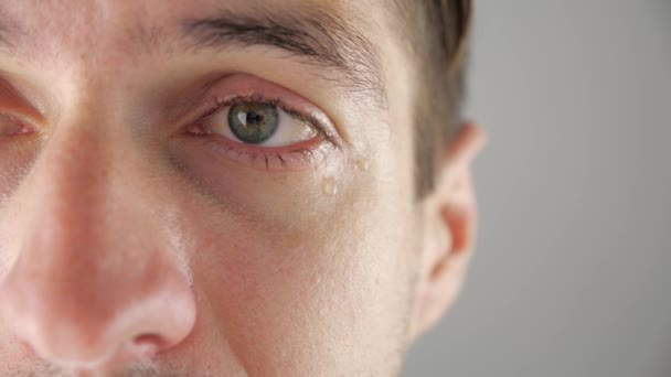 Half face portrait of sad man crying with tears in eye. Man in despair. — Stock Video