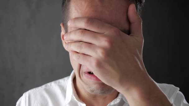 Giovane disperato che piange e si copre il viso con la mano. Uomo d'affari che piange di lacrime. Il crollo delle imprese . — Video Stock