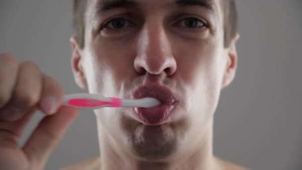 Primer plano del joven cepillarse los dientes en el baño y dejar de becuse de un dolor de muelas — Vídeo de stock