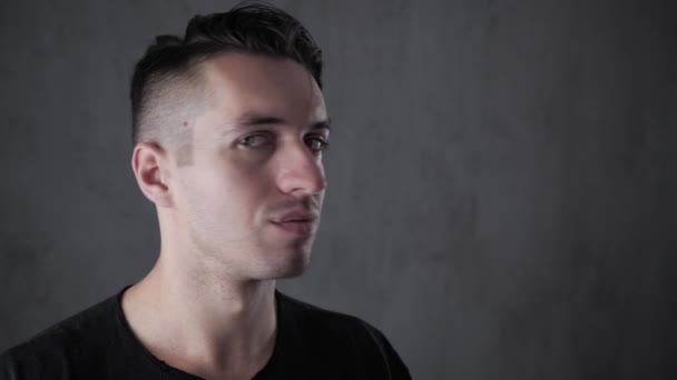 Closeup portrait of young stylish man at gray background — Stock Video