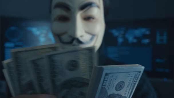 Cherkassy, Ukraine, January 04 2019: anonymous in Guy Fawkes mask recounts bills of dollars earned by hacking in the darknet — Stock Video