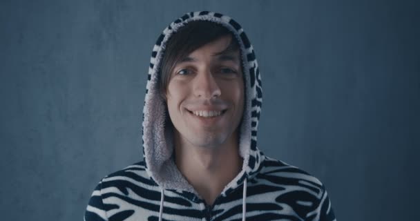 Portrait of Young Man in kigurumi zebras on gray background. — Stock Video