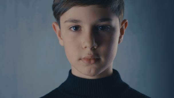 Close-up portrait of cute boy looking at camera — Stock Video