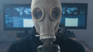 Karanlık veri merkezindeki gaz maskeli adam portresi duman dolu. Postapokalipsis dünyası