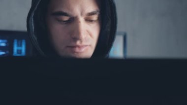 Veri merkezindeki bir bilgisayarda çalışma başlıklı yakışıklı erkek hacker.