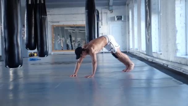 Portrait of Muscular Shirtless Fitness Athlete Covered in Sweat Does Push-ups into Gym. Cross Fitness Workout Training — Stock Video