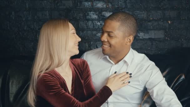 Mixed race couple in love on a date flirts with each other — Stock Video