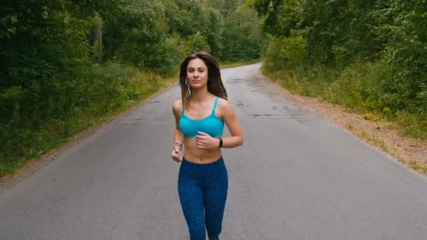 Aantrekkelijke jonge vrouw gerund in zomer bos of Park. Meisje joggen buiten. Cardio run — Stockvideo