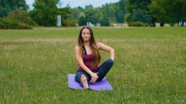 Genç güzel kadın açık havada yoga yapıyor. Sağlıklı yaşam konsepti. Sakinlik ve rahatlama, kadın mutluluğu.