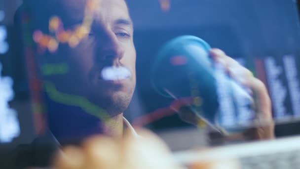 Double exposure: Man Working at Laptop and checks stock market. Reflection in the Monitor: Successful Businessman Working on a Laptop in office and Drinking Tasty Coffee. — Stock Video