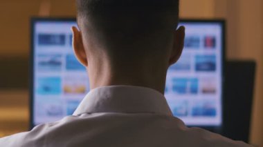 Bilgisayar Monitörü'nde İnternet Sitelerinde gezinen Adamı geri görüntüle. Web Sayfaları Sörf, Internet'te bilgi arama kavramı.