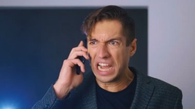 Sinirli iş adamı müfettişe bağırıyor, cep telefonuyla konuşuyor..