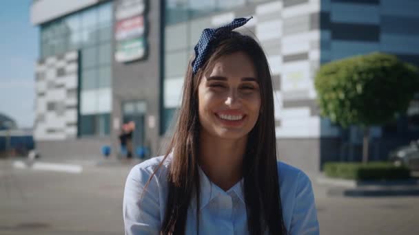 Portret młoda atrakcyjna kobieta uśmiech spojrzeć w kamerę w mieście. Zbliżenie uśmiechniętej pięknej bizneswoman stojącej w pobliżu biurowca — Wideo stockowe