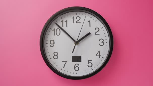 Single white office clock hanging on a pink color wall — Stock Video