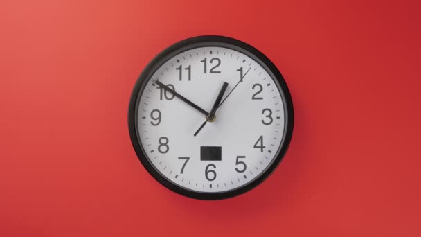 White office clock hanging on a red color wall — Stock Video