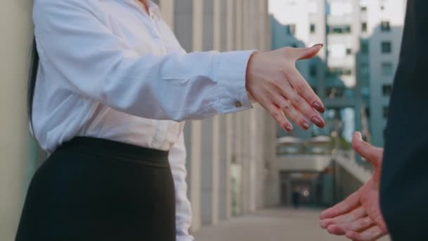 Uomini d'affari che si stringono la mano. Uomo d'affari che stringe la mano a una collega donna all'aperto su business office buildings background — Video Stock