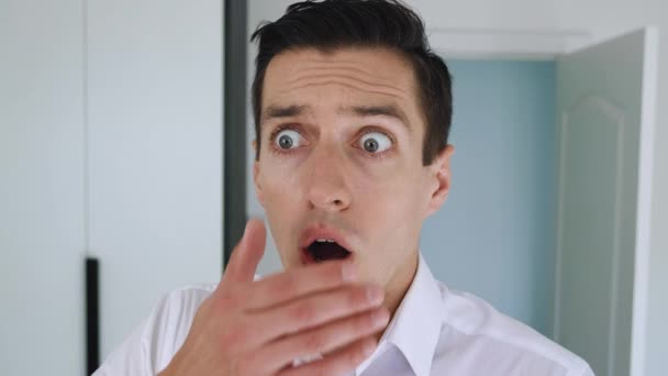 Portrait of frightened businessman shocked and covers his mouth in surprise. The concept is an unpleasant surprise. The man is suddenly terrified. — Stock Video