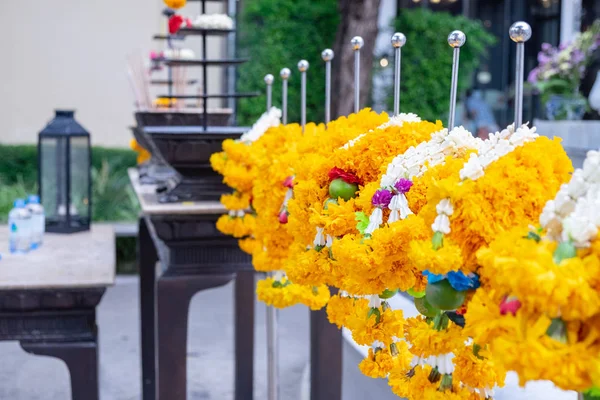 Flower garland made from marigolds and various flowers to bring worship what respect