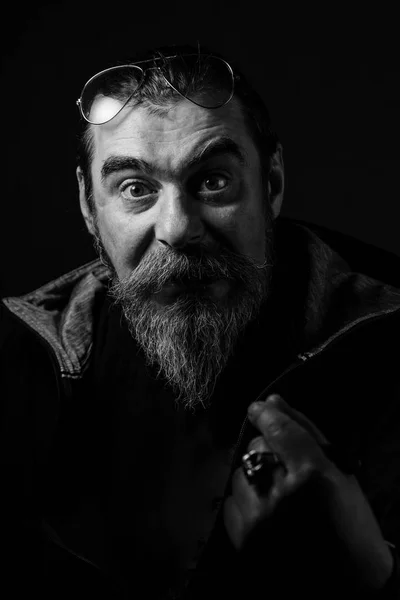 Black and white portrait of serious young man Isolated on black