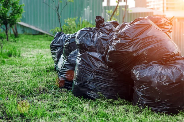 Heap garbage plastic bags many in the garden, pollution from tra