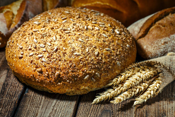 loaf of bread on wooden background, food closeup.Fresh homemade 