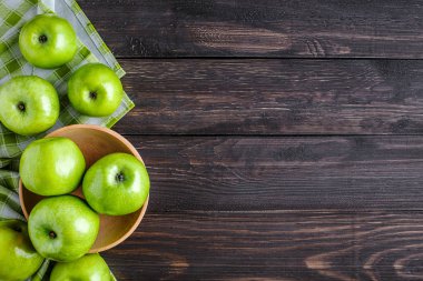 Olgun yeşil elma ve elma dilimleri eski ahşap arka planda. Vege