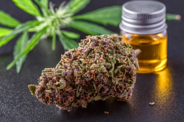 Medical marijuana flower buds. Recreational marijuana strain. Cannabis strain. Weed bud in the glass jar. Dispensary menu. Hemp buds.isolated on black - medical marijuana concept