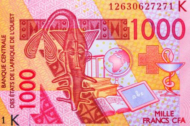 Batı Afrika devletleri 1000 frank 2003.Deve. CFA frankı 14 Afrika ülkesinde kullanılıyor. Bir zamanlar Akan halkı tarafından altın tartmak için kullanılan stilize edilmiş bir testere balığı. Dünya para toplama. Bonistikler..