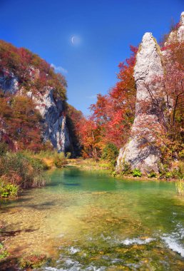 Plitvice Waterfalls in Croatia is one of the famous famous places in Europe, very beautiful. The jets of water on the background of autumn forests at sunrise are very picturesque clipart