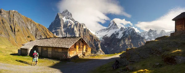 Traditional alpine mountain house in Chamonix for shepherds cows and sheep. All wooden, natural, attracts tourists, cyclists ride mountain bikes. Athlete studying a descent map