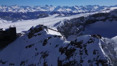 Panoramic Aerial View of Glacier 3000 with Alpine Peaks, Suspended Bridge (Peak Walk), Cable Car Lift, and Ski Resort at the Summit in Switzerland
