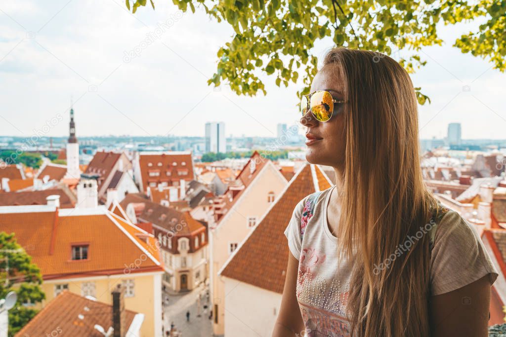 Young girl exploring Tallinn city including old town, modern district Rotermann