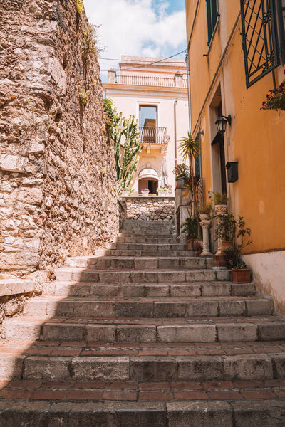 July 04, 2018. Taormina, Italy. Beautiful old town of Taormina with small streets, flowers, cafes and palms.